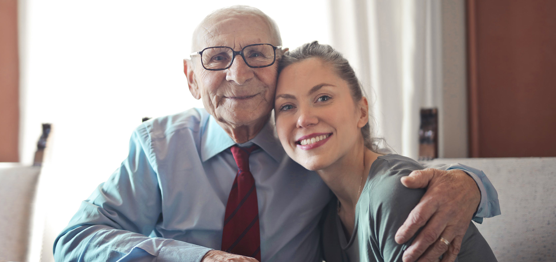Elderly white man and granddaughter embracing- Photo by Andrea Piacquadio from Pexels